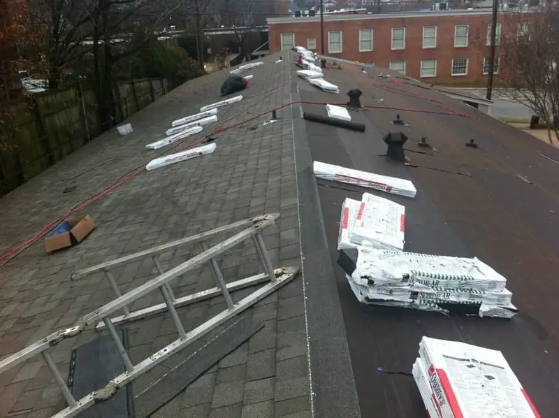 Shingle bundles staged on a roof during a tear-off and replacement