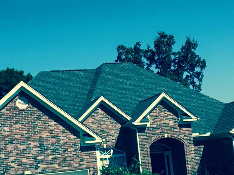 New green architectural shingle roof on a brick home in Little Rock