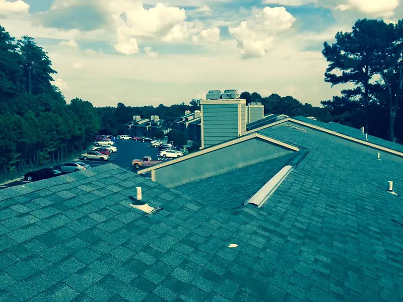 Green shingle roof with a lake view