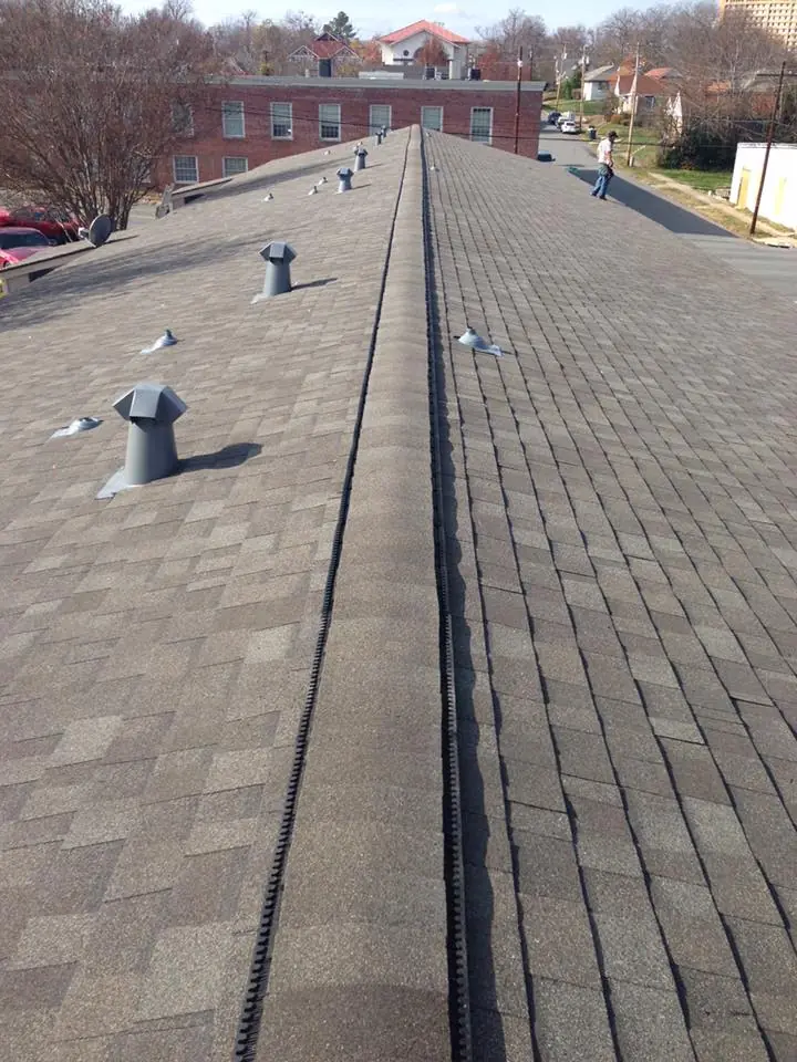 Ridge vent and pipe boots along a long commercial roof