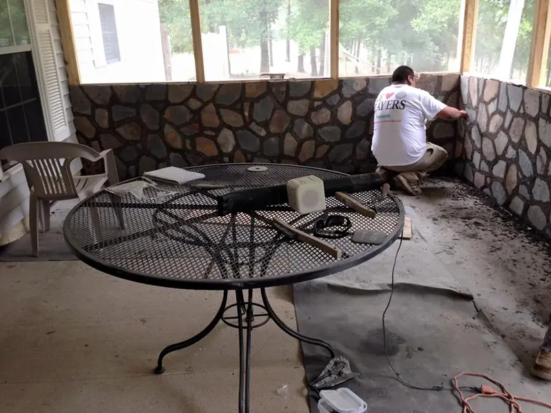 Stone wall going up on a covered patio