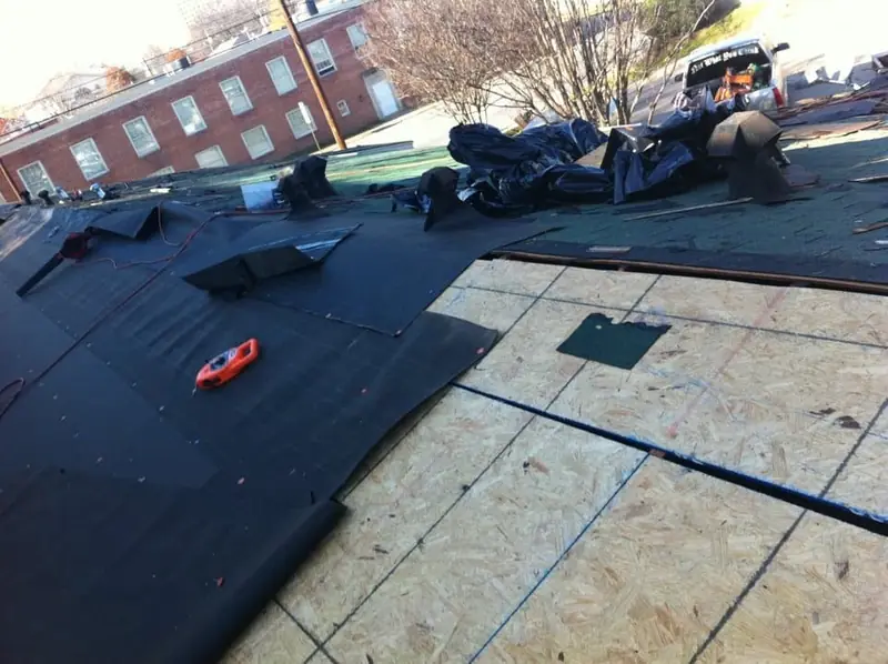 Roof deck with underlayment and new shingles in progress